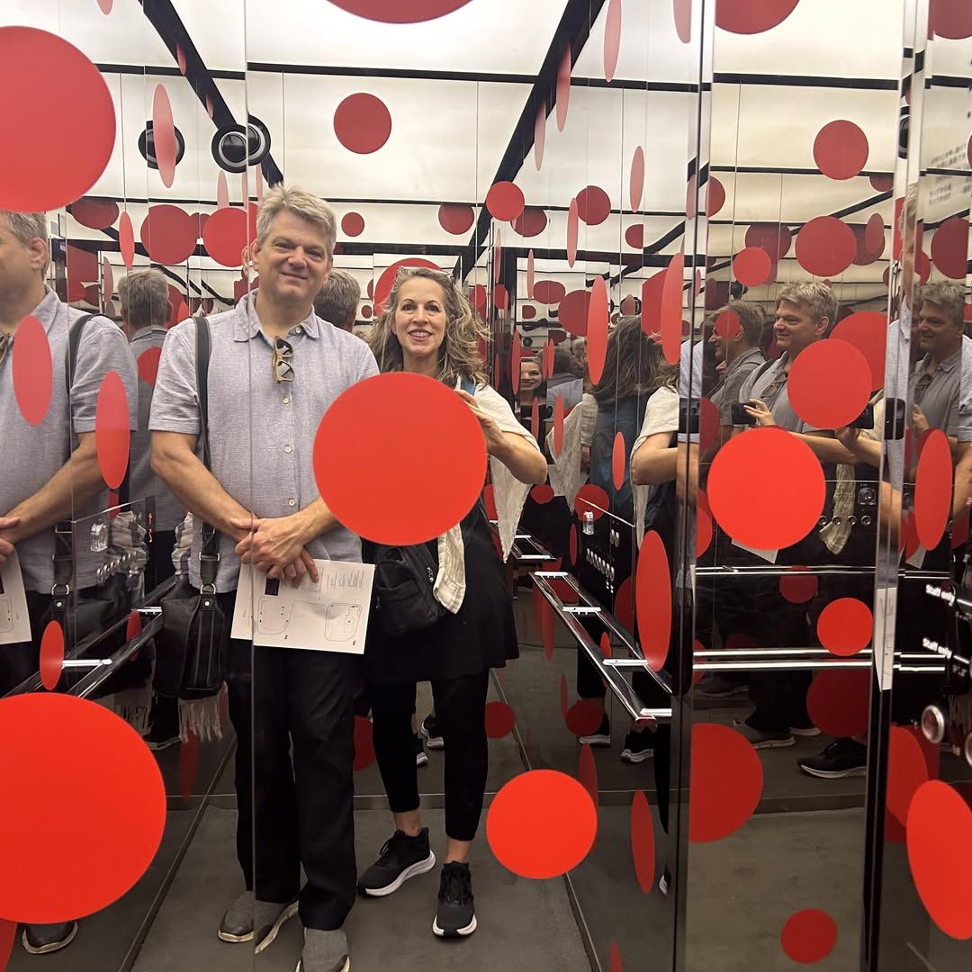 Shana and her husband in Yayoi Kusama's polka-dot mirror room