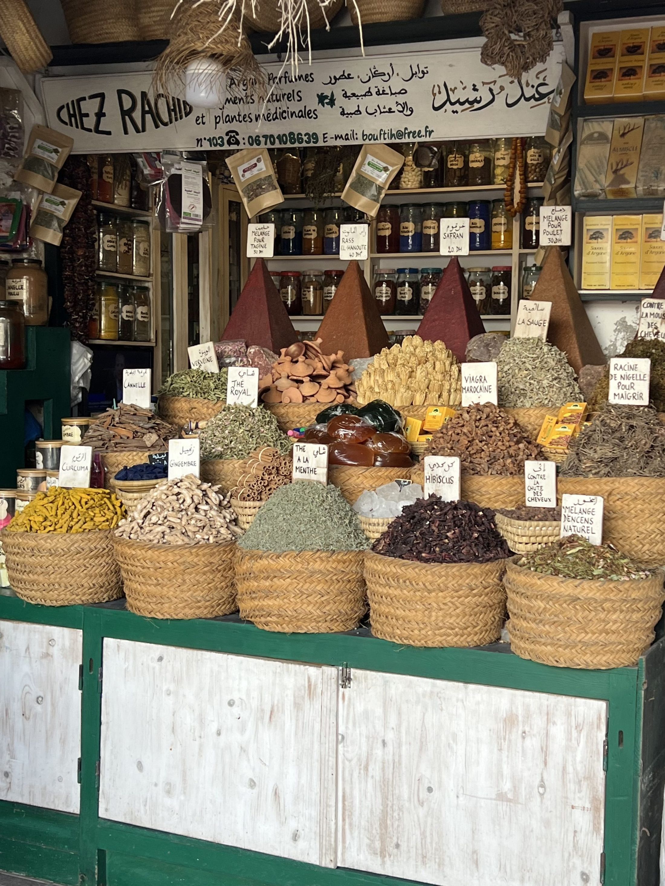 Baskets of spices stacked in cones at a market stall in Morocco