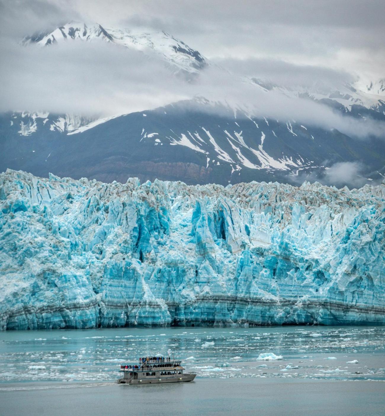 A blue glacier face meeting the water in Alaska