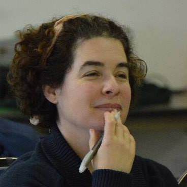 Rebecca Novick as a young theater director, pen in hand