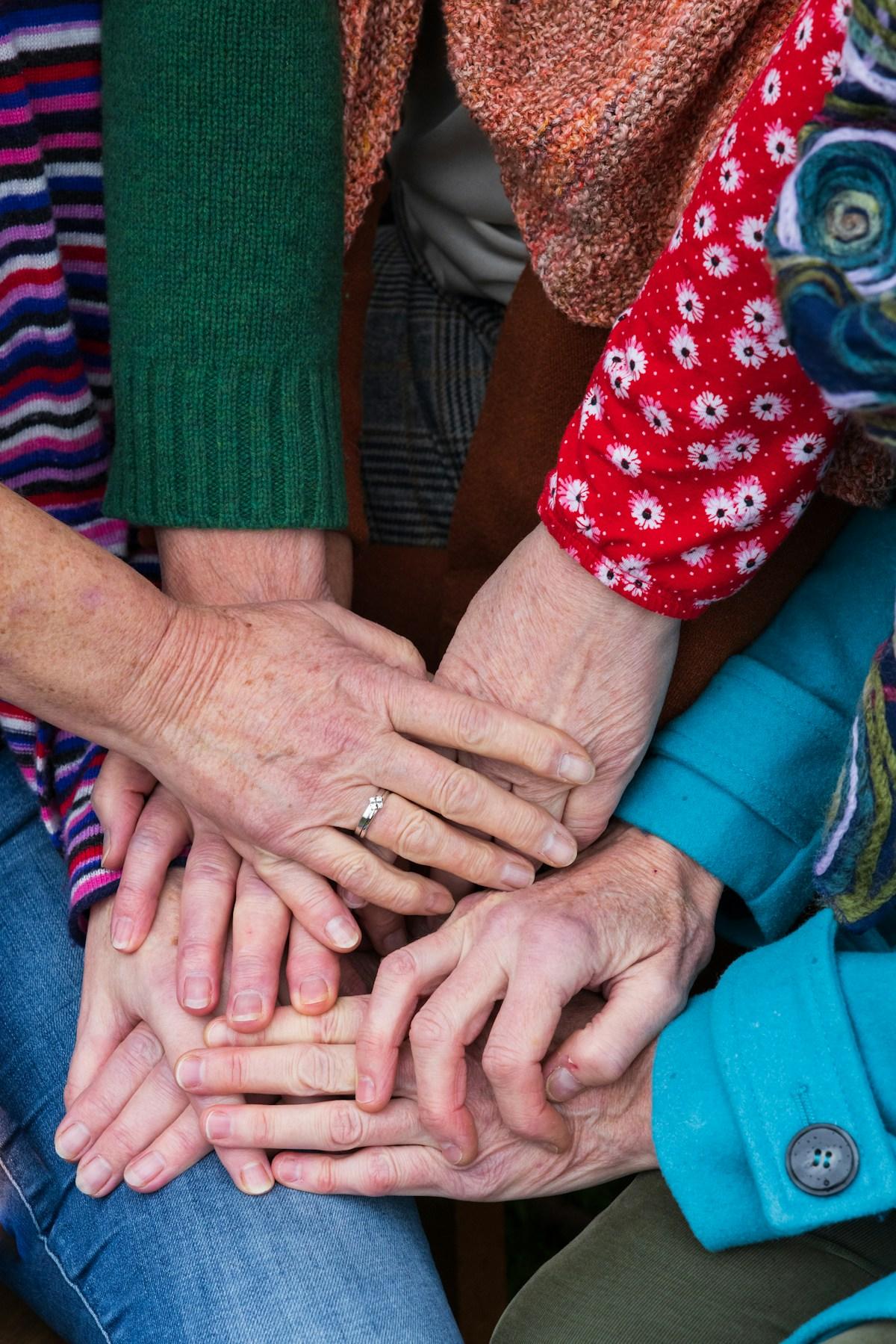 Hands of several generations stacked together