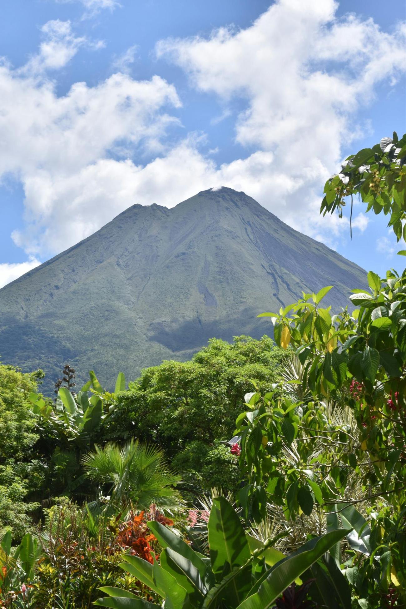 A volcano rising above green rainforest in Costa Rica