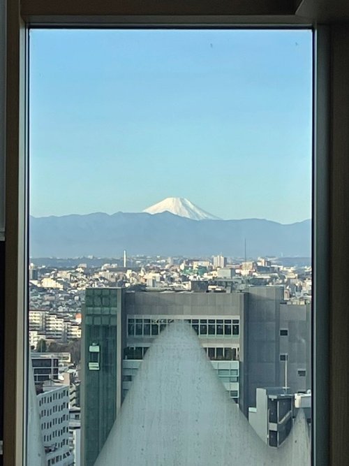 Mount Fuji seen through a high window over Tokyo